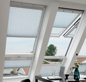 Three large VELUX windows installed together, creating a bright, airy space.